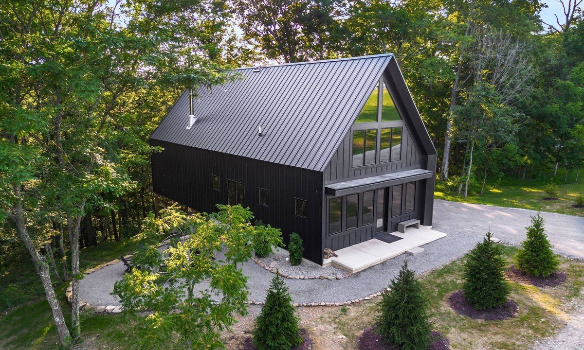 New Plymouth Cabin | Escape to this large Hocking Hills cabin! Sleeps 8 (2BR/Loft/2.5BA). A true luxury Hocking Hills cabin featuring floor-to-ceiling windows, a suspended fireplace, and nearby outdoor sauna pods.