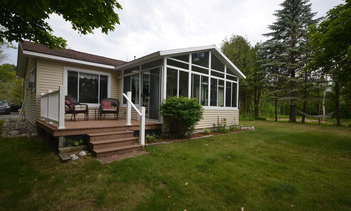 Traverse City House | Waterfront home Lake Leelanau. Enclosed porch, WIFI. Canoe, row boat Dog ok.