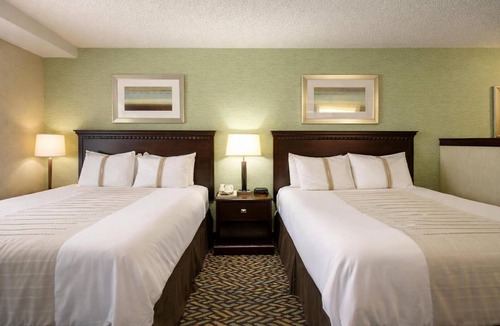 Devils Lake Hotel | 2 Rooms near Lake Region Heritage Center | Free Parking, Bfast, & Pool Access!