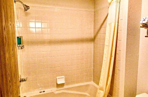 Boulder Junction Apartment | A dog friendly room with two queen beds, private bathroom with jetted tub, mini fridge, and single-serve coffee maker.