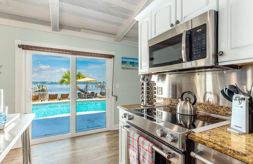 Stuart House | Aquatopia North: Riverfront beach house, w/dock, heated pool + hot tub & more!