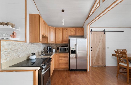 Carp Lake House | Bay Breeze (Carp Lake, MI) Summer Beachfront Bliss | Swim & Relax on Cecil Bay