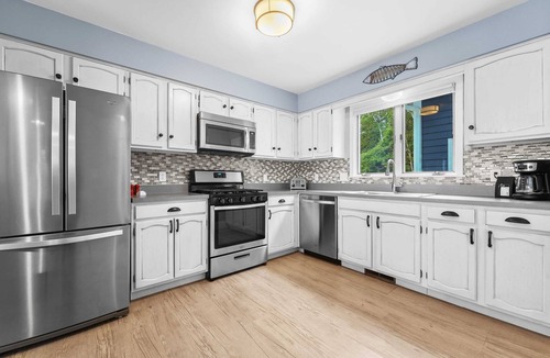 Suttons Bay House | Bayside Serenity with Hot Tub! Dog Friendly!
