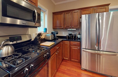 Lagoon Heights House | Classic, private estate with a large lot, a stone patio & a fireplace!