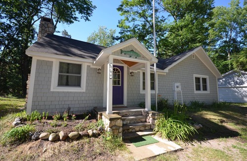 Glen Arbor House | Cottage in Glen Arbor with Crystal River frontage, canoe, FP, A/C, Dogs ok