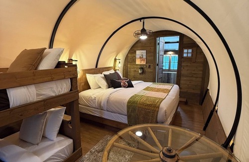 Pinnacles Entrance Badlands Hotel | Covered Glamping Wagons: Step Into the Frontier With Modern Comforts