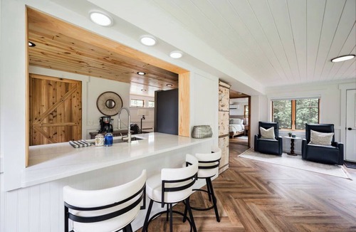 East Jordan Cabin | Cozy River Cabin | Private Deck & Shared Riverside
