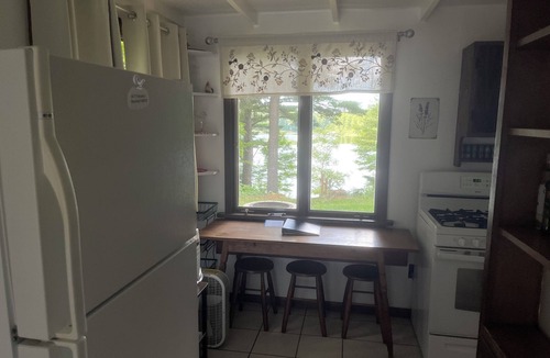 Lake Ann House | Cozy waterfront sunset cottage on Herendeene Lake in Lake Ann, Dock, Dog ok
