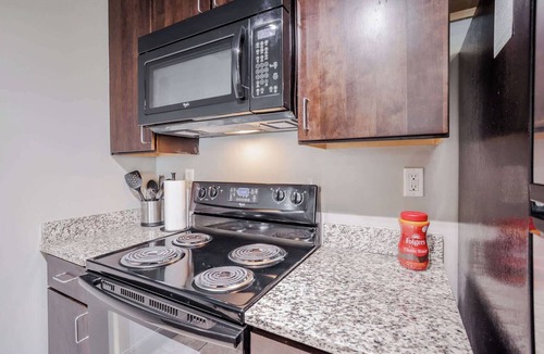 Central Business District Apartment | CozySuites at the Banks gym, pool 15