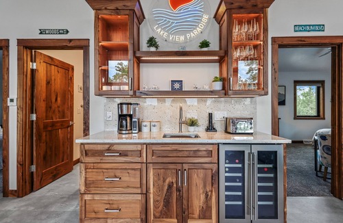 Oneida County Cabin | Escape to Lakeview Paradise, a luxury 4-bed, 3-bath lakefront retreat in Tripoli, WI. Each bedroom has a king bed, and the 2,560 sq. ft. home features high-end finishes, cozy comforts, and stunning lake views from a private 24-ft deck or hot tub.