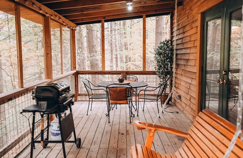 Carbon Hill Cabin | Evergreen Hideaway is a cabin nestled under tall pines.