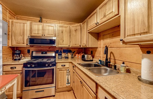 Three Lakes Cabin | Lakeside cabin with a firepit, sunroom, & seasonal dock