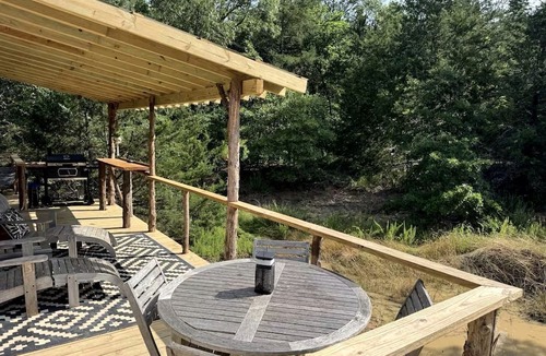 Honey Grove House | Luxurious Remodeled Airstream with Wraparound Deck and Spa near Honey Grove, Texas