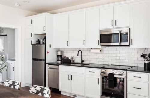 Bellaire Apartment | Pet-Friendly 2BR Family Suite in Boutique Resort w/Hot Tubs, Sauna, & Fire Pit!