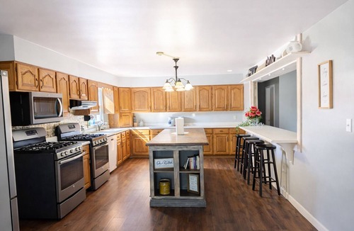 Thompsonville House | Relax at a cozy countryside retreat with a private hot tub, pond views & fire pit — pure bliss. By: Timber Oaks Vacation Rentals