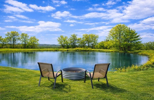 Thompsonville House | Relax at a cozy countryside retreat with a private hot tub, pond views & fire pit — pure bliss. By: Timber Oaks Vacation Rentals