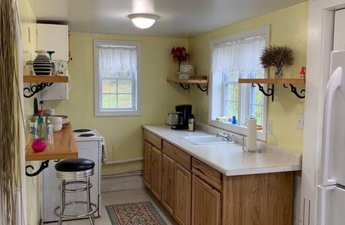 Eastport House | Sea-Breeze Cottage perched on the edge of the bay.