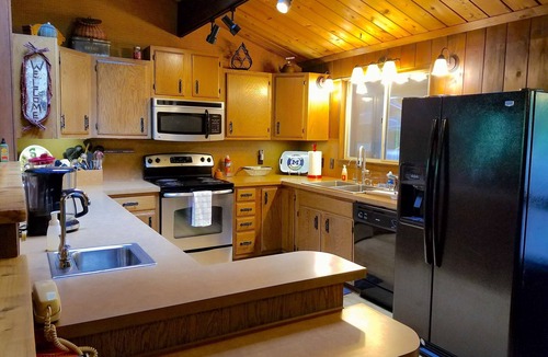 Mayfield Cottage | Secluded Cottage on the Boardman River w/Hot Tub & Fireplace