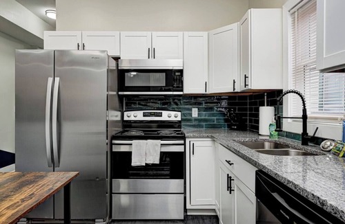 Fountain Square House | Sleeps 6 comfortably: 3 stylish bedrooms with plush bedding and blackout curtains. Music-themed decor: curated vinyls, vintage instruments, and artwork. This short-term rental features bold décor, modern amenities, and walkable access to