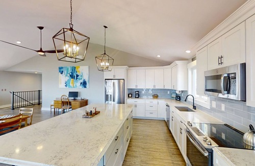 Mid-Coast and Islands House | This spacious home offers a FANTASTIC covered porch, perfect to spend your days gazing at the ocean!