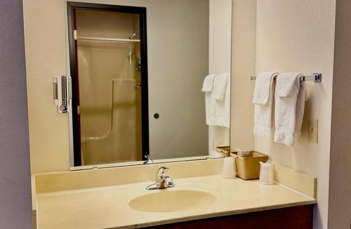 Boulder Junction Apartment | Two queen beds, private bathroom, mini fridge, and single-serve coffee maker.