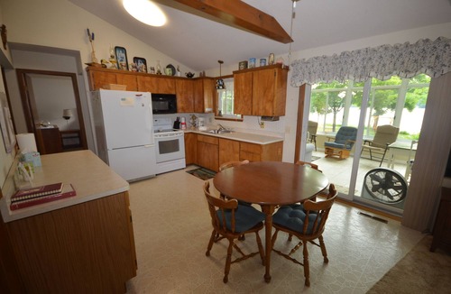 Traverse City House | Waterfront home Lake Leelanau. Enclosed porch, WIFI. Canoe, row boat Dog ok.