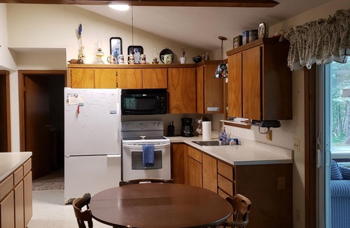 Traverse City House | Waterfront home Lake Leelanau. Enclosed porch, WIFI. Canoe, row boat Dog ok.