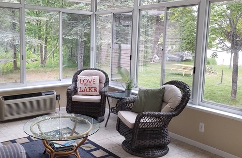 Traverse City House | Waterfront home Lake Leelanau. Enclosed porch, WIFI. Canoe, row boat Dog ok.