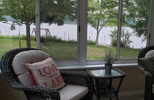 Traverse City House | Waterfront home Lake Leelanau. Enclosed porch, WIFI. Canoe, row boat Dog ok.