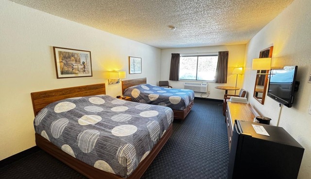 A dog friendly room with two queen beds, private bathroom with jetted tub, mini fridge, and single-serve coffee maker.