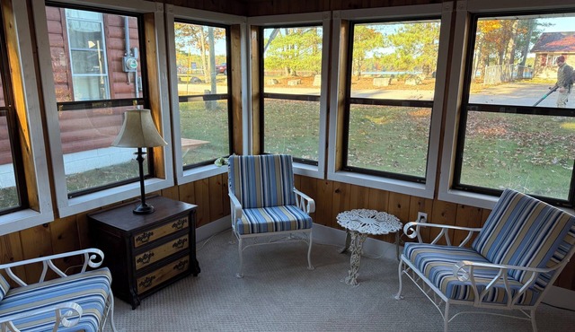 Bear Lake Hideaway - your rustic Bear Lake retreat! Hop on the ATV trails out back, then kick off your boots and unwind in our front Seasons room with a lake view. Walk across the street to public beach access.