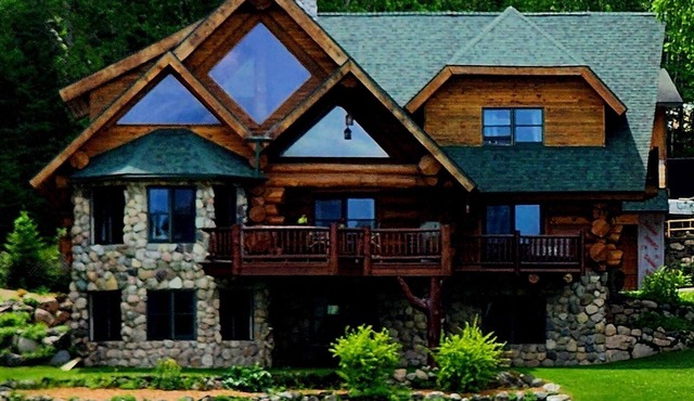 Beautiful handmade log home on private sand beach at the end of Big Bay