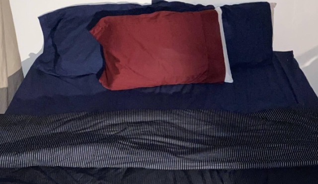 Beds in living room space blocked off by curtains!