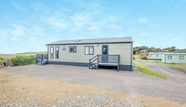 Country and modern cladded lodge with sea views.