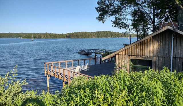 Cozy waterfront log cottage with huge outdoor living area.