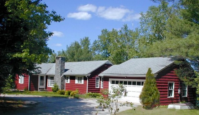 Family compound on Thomas Pond featuring main house and two small cottages.