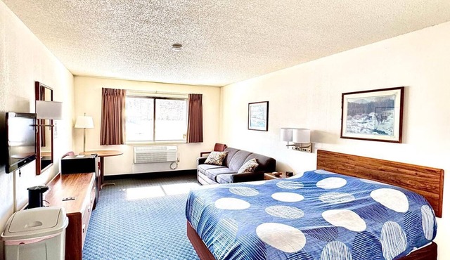 One queen bed, private bathroom with jetted tub, mini fridge, and single-serve coffee maker.