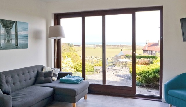 Part of a small terrace of bungalows with uninterrupted views towards the sea.