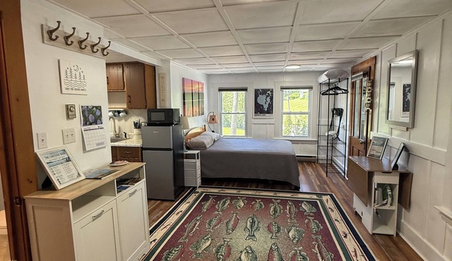 Sebago Lake studio-style condo with enclosed sunroom and sunset views