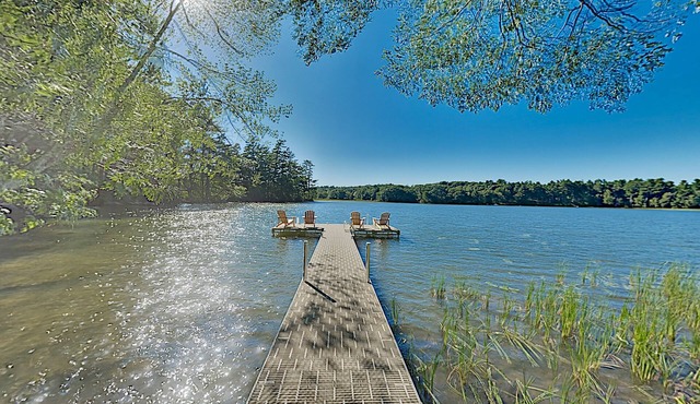 Spacious lakefront home on lush 5-acre lot with sunny deck & private dock