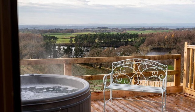 This luxury lodge has its own decking with hot tub